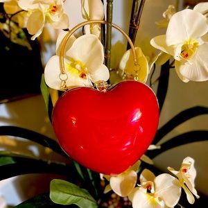 A chic and elegant heart-shaped clutch bag with romantic feminine touch.